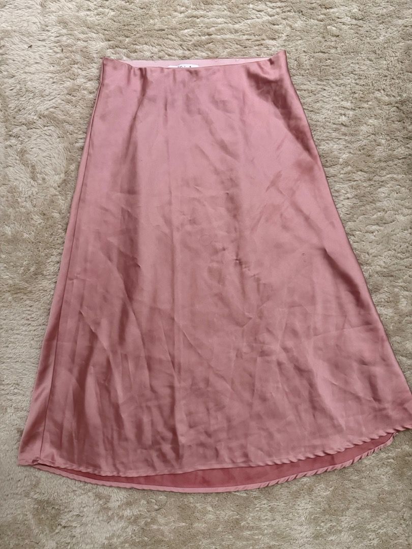 Pink Satin Midi Skirt (Category: Skirts) located in Caloocan City. Submitted by croissant8765 (Listing ID 1464314107, Image 2). Description: - Flowy pink satin midi skirt - Features a slight sheen - Adorable wavy edge detail on the hem - Highly versatile for dressing up or down - Easy to style for various occasions.