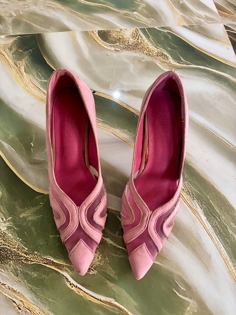 Pink Suede Mesh Pointed Toe Heels (Category: Heels) located in Tabuk. Submitted by twotimestooo (Listing ID 1464175324, Image 1). Description: - Stunning pink suede heels - Elegant mesh detailing - Unique curved heel design - Pointed toe for a sophisticated look - Ideal for dressing up any outfit - Minor scuffs on soles and heels.