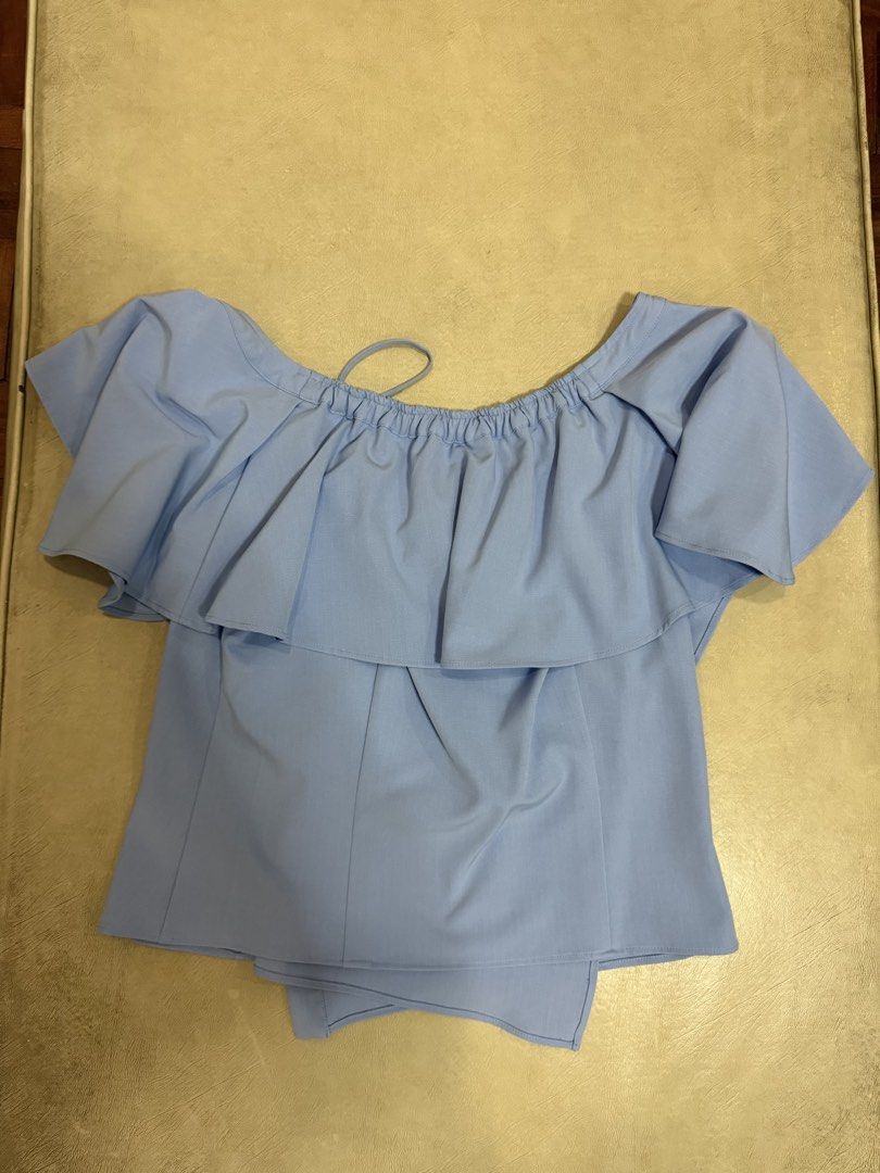 Plains & Prints Light Blue Ruffle Off-Shoulder Top (Category: Blouses) located in Manila. Submitted by abigailyao21949 (Listing ID 1464187699, Image 2). Description: Plains & Prints Light Blue Ruffle Off-Shoulder Top •Size: M •Price: 800 php •In very good condition •Barely used - Features ruffled overlay - Button details on the side -Vneck style in front -Garterized on upper back.