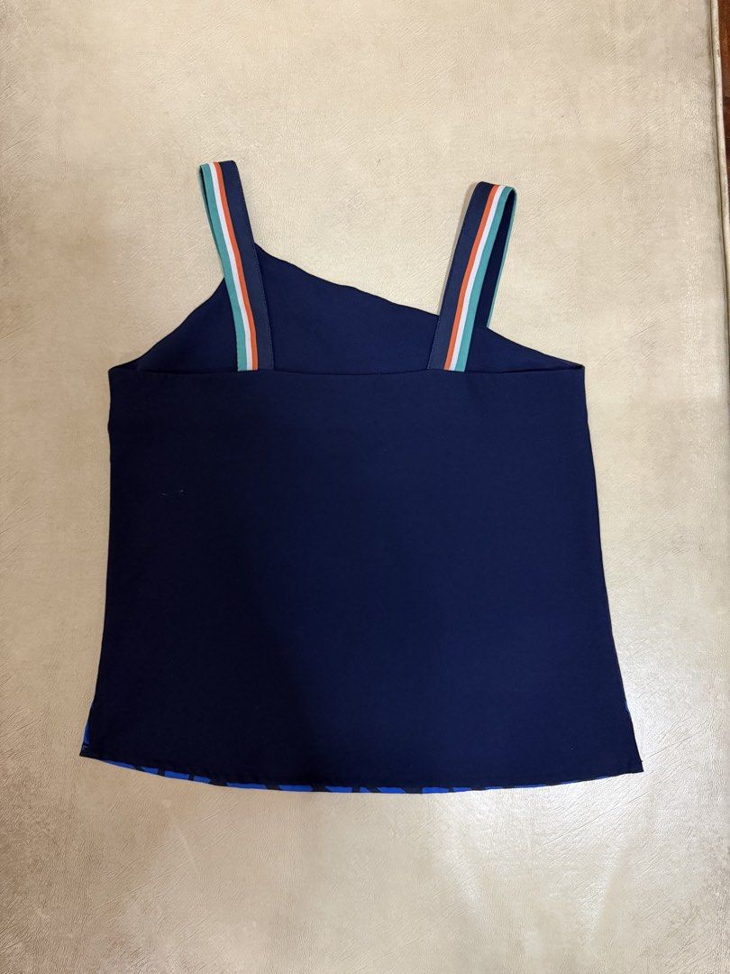 Plains & Prints Navy Blue Asymmetrical Blouse with Print (Category: Blouses) located in Manila. Submitted by abigailyao21949 (Listing ID 1464189503, Image 2). Description: Plains & Prints Navy Blue Asymmetrical Blouse with Print •Size: XS •Price: 560 php •In good condition •Slight mark on front and back (it was already there when i bought it) - Adorable bird applique with floral details on the front - Colorful stripe detail on the straps.
