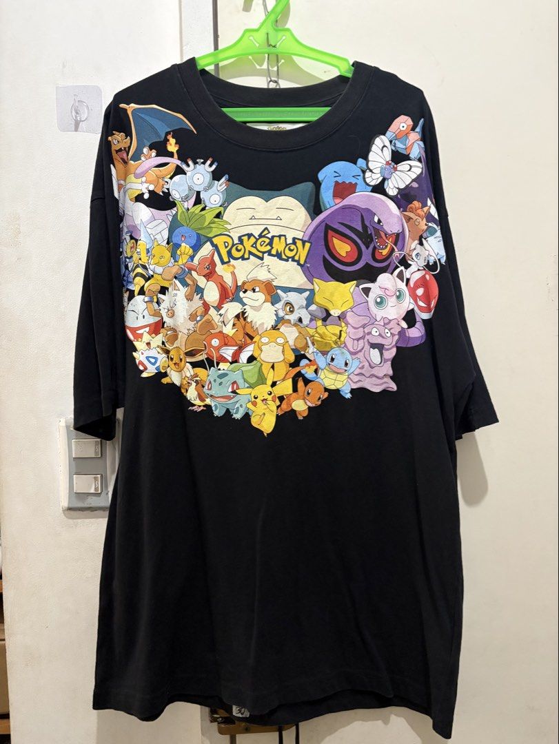 Pokemon T-shirt (Category: Tshirts & Polo Shirts ) located in Manila. Submitted by dominicoab75406 (Listing ID 1464175543, Image 2). Description: - Black t-shirt with a large, vibrant graphic print of popular Pokemon characters. - Features iconic characters like Snorlax, Pikachu, Squirtle, and many others. - Made for ultimate comfort, perfect for everyday wear. - An essential item for any dedicated Pokemon fan or collector..