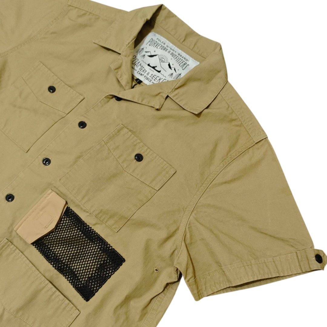 POLER JP Short Sleeve Utility Camp Shirt (Category: Tshirts & Polo Shirts ) located in Quezon City. Submitted by oldturnedtogold (Listing ID 1464165044, Image 2). Description: POLER JP Short Sleeve Utility Camp Shirt Size Small Beige Shoulder Width - 18.5" Body length - 26" Chest width - 23" Sleeve Length - 8.5" Details: - 100% cotton fabric - camp collar - 4 front patch pockets alongside a distinct mesh panel pocket on the left side - button fro