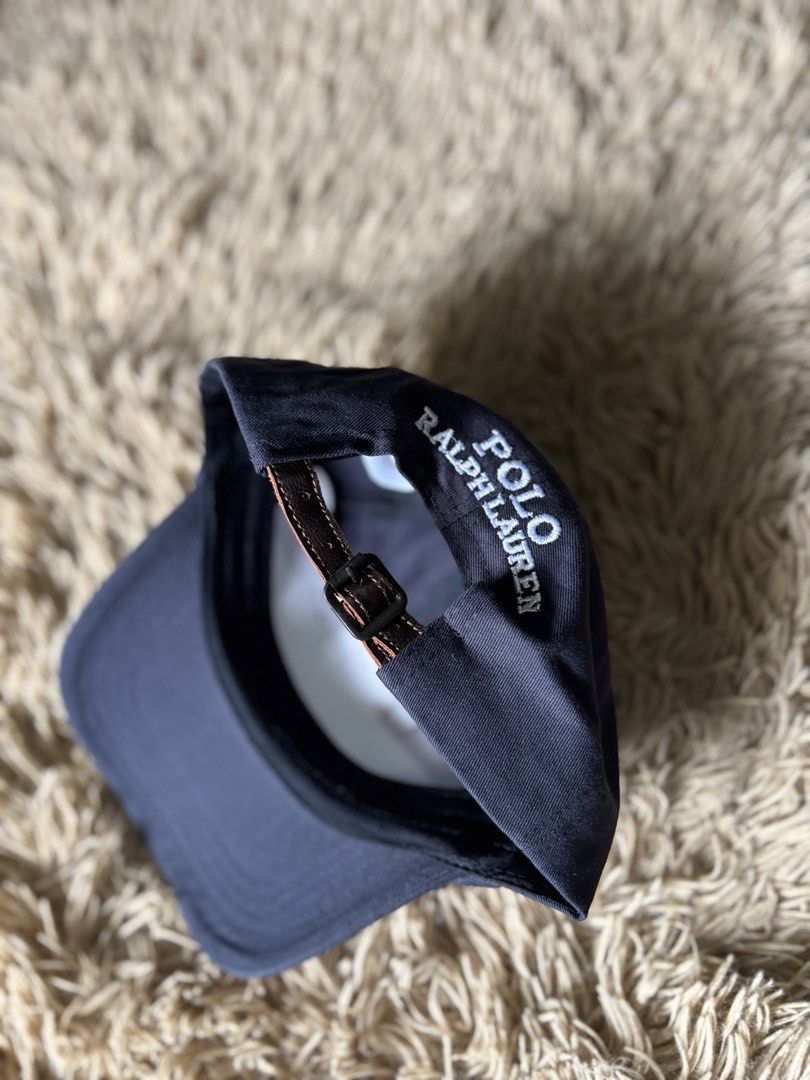 Polo Ralph Lauren Bear Cap Navy Blue (Category: Caps & Hats) located in Quezon City. Submitted by nojthrift (Listing ID 1464250943, Image 3). Description: - Classic navy blue Polo Ralph Lauren cap - Features iconic Polo Bear embroidery on the front - Adjustable strap at the back for a comfortable fit - Made with quality materials for durability - Perfect for everyday casual wear - Polo Ralph Lauren logo visible on the inside band.