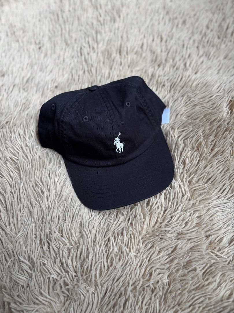 Polo Ralph Lauren Black Cap (Category: Caps & Hats) located in Quezon City. Submitted by nojthrift (Listing ID 1464251776, Image 1). Description: - Classic black cap from Polo Ralph Lauren - Iconic polo player logo embroidered on the front - 'POLO' embroidered on the back - Adjustable strap for a comfortable fit - Made from 100% cotton - One size fits most.