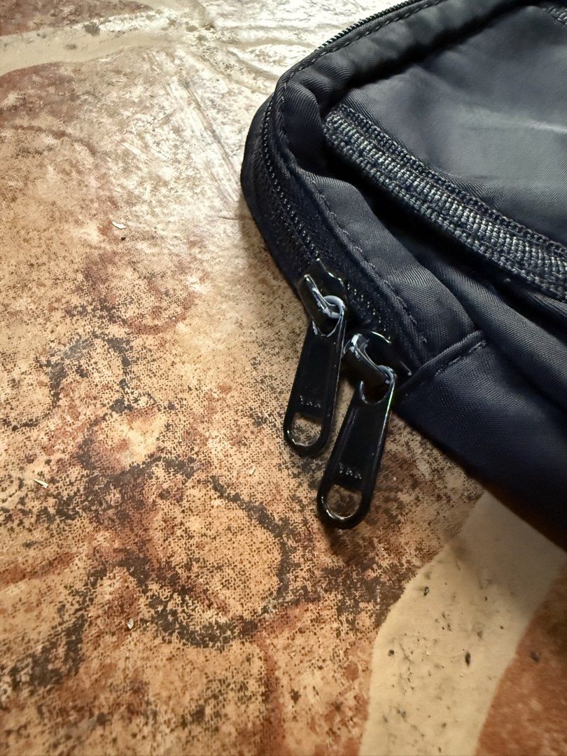 Porter Tokyo Black Nylon Pouch Bag “Authentic” (Category: Sling Bags) located in Cavite. Submitted by stolengoods116 (Listing ID 1464236416, Image 3). Description: Black Porter Tokyo pouch. Made from durable nylon. Has a main zippered compartment and a smaller front pocket. The back has a strap with a buckle and a D-ring. Great for carrying essentials. Compact size..