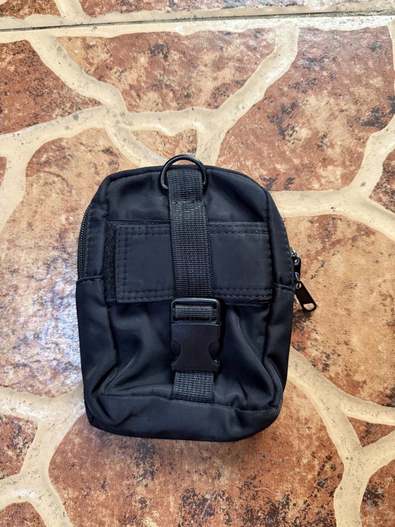 Porter Tokyo Black Nylon Pouch Bag “Authentic” (Category: Sling Bags) located in Cavite. Submitted by stolengoods116 (Listing ID 1464236416, Image 2). Description: Black Porter Tokyo pouch. Made from durable nylon. Has a main zippered compartment and a smaller front pocket. The back has a strap with a buckle and a D-ring. Great for carrying essentials. Compact size..
