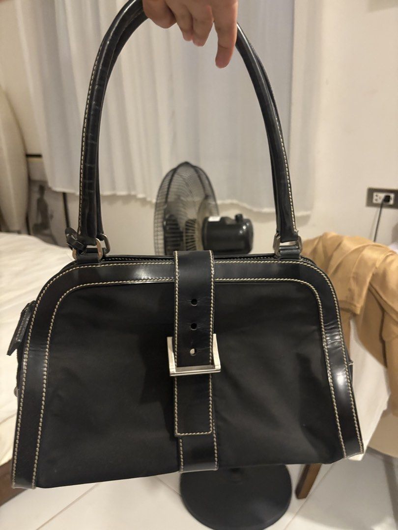 Prada Black Nylon Leather Trimmed Shoulder Bag (Category: Luxury Bags & Wallets) located in Quezon City. Submitted by mileena3 (Listing ID 1464234175, Image 2). Description: - Authentic Black Prada Shoulder Bag - Durable Nylon Body with Leather Trim - Elegant Leather Handles - Silver Hardware Details - Secure Zipper Closure with Lock and Key - Classic and Versatile Design - Ideal for Everyday Use.