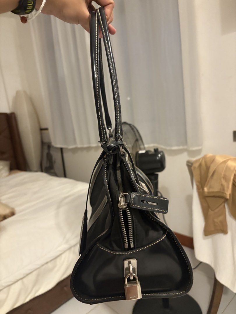 Prada Black Nylon Leather Trimmed Shoulder Bag (Category: Luxury Bags & Wallets) located in Quezon City. Submitted by mileena3 (Listing ID 1464234175, Image 1). Description: - Authentic Black Prada Shoulder Bag - Durable Nylon Body with Leather Trim - Elegant Leather Handles - Silver Hardware Details - Secure Zipper Closure with Lock and Key - Classic and Versatile Design - Ideal for Everyday Use.