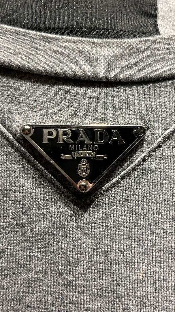 Prada Enamel Triangle Logo Cotton T-Shirt (Category: Luxury Apparel) located in Makati City. Submitted by tonyalavaro (Listing ID 1464249785, Image 2). Description: Selling Prada Enamel Triangle Logo Cotton T-Shirt there is a missing steel cog..