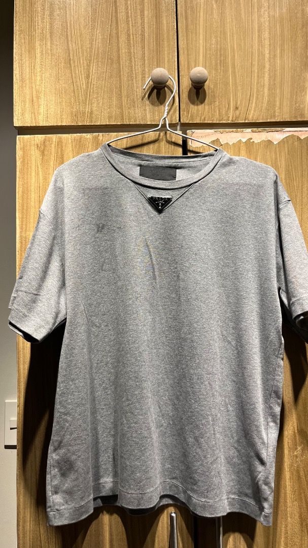 Prada Enamel Triangle Logo Cotton T-Shirt (Category: Luxury Apparel) located in Makati City. Submitted by tonyalavaro (Listing ID 1464249785, Image 1). Description: Selling Prada Enamel Triangle Logo Cotton T-Shirt there is a missing steel cog..