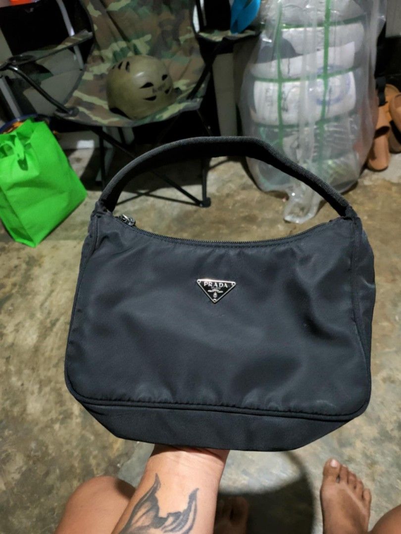 Prada Nylon Handbag (Category: Luxury Bags & Wallets) located in Manila. Submitted by bertingggg (Listing ID 1464294314, Image 1). Description: - Authentic Prada nylon handbag - Iconic triangle logo on the front - Secure zipper closure - Durable nylon handle - Interior tag marked '39' - Ideal size for everyday use.