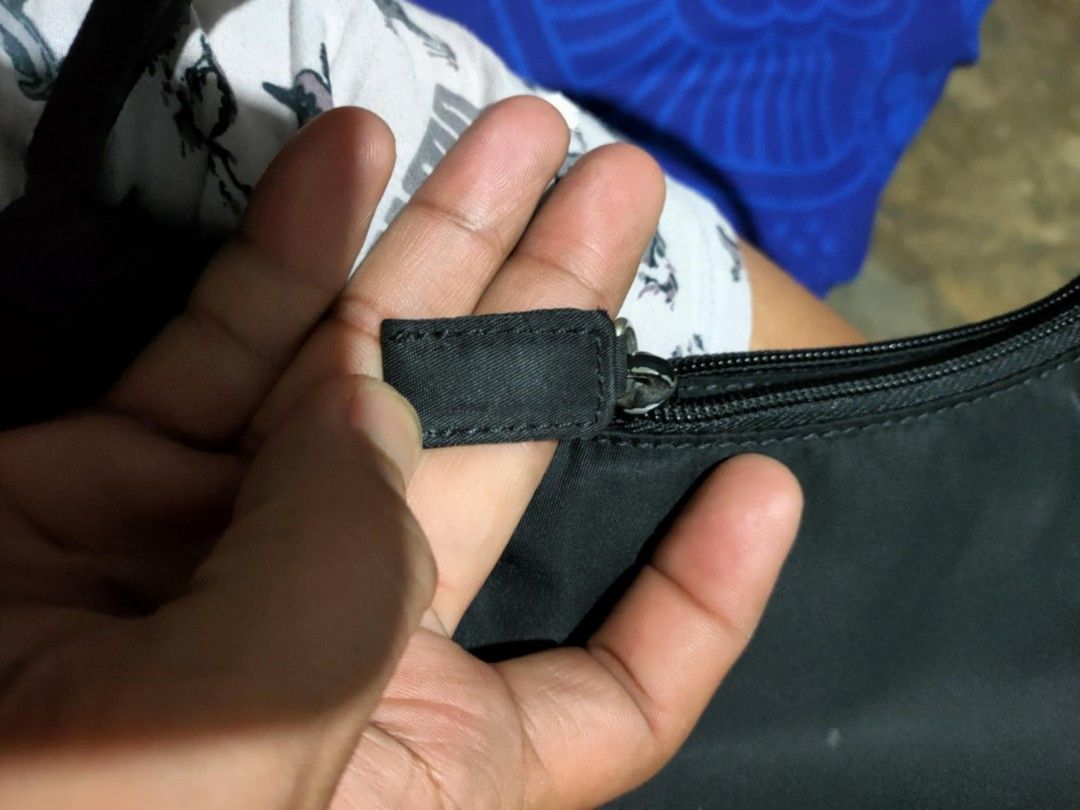 Prada Nylon Handbag (Category: Luxury Bags & Wallets) located in Manila. Submitted by bertingggg (Listing ID 1464294314, Image 3). Description: - Authentic Prada nylon handbag - Iconic triangle logo on the front - Secure zipper closure - Durable nylon handle - Interior tag marked '39' - Ideal size for everyday use.