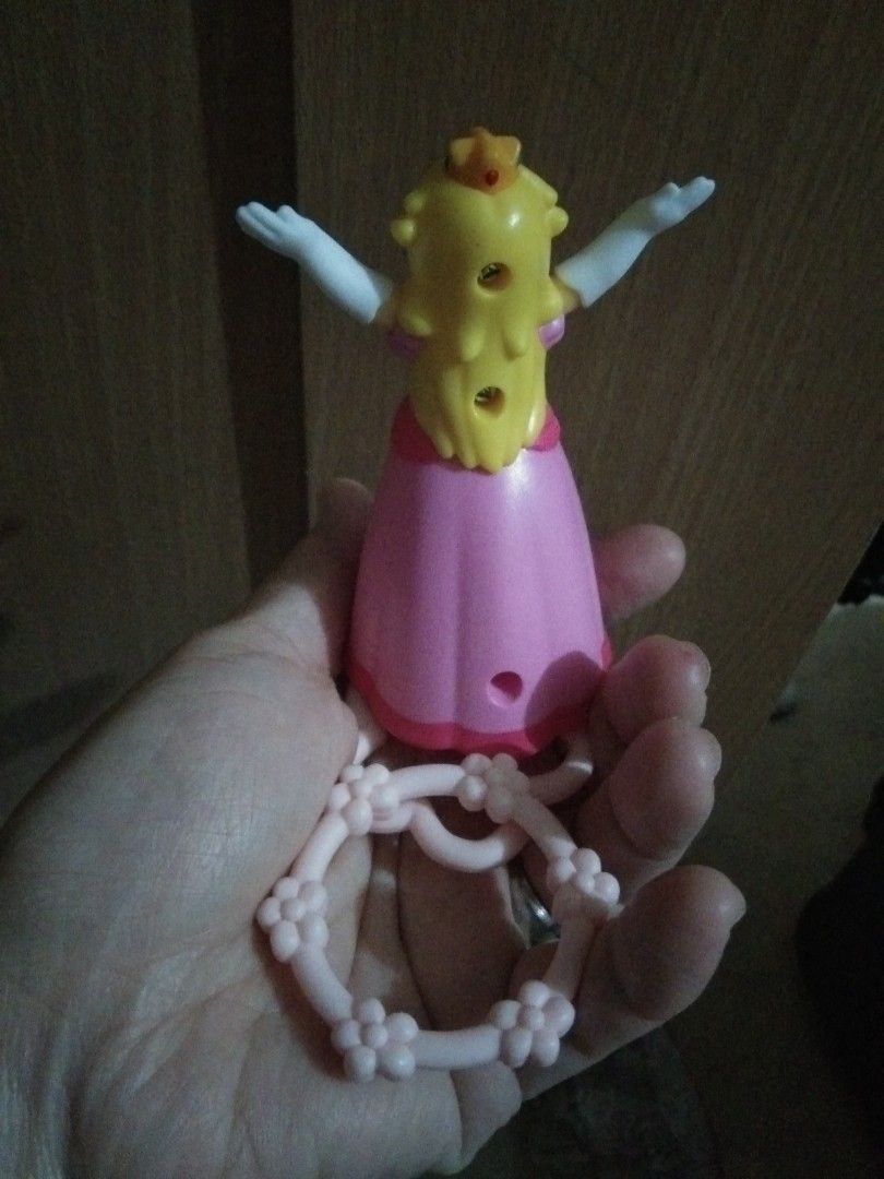 Princess Peach hoop Toy Figure (Category: Character Goods) located in Quezon City. Submitted by eidorableshop (Listing ID 1464280054, Image 3). Description: - Adorable Princess Peach toy with keychain attachment. - Features a charming pink and yellow color scheme. - Princess Peach is dressed in her iconic pink dress and white gloves. - The keychain itself is pink and adorned with lovely flower details. - Ideal for fans of the popular game series.