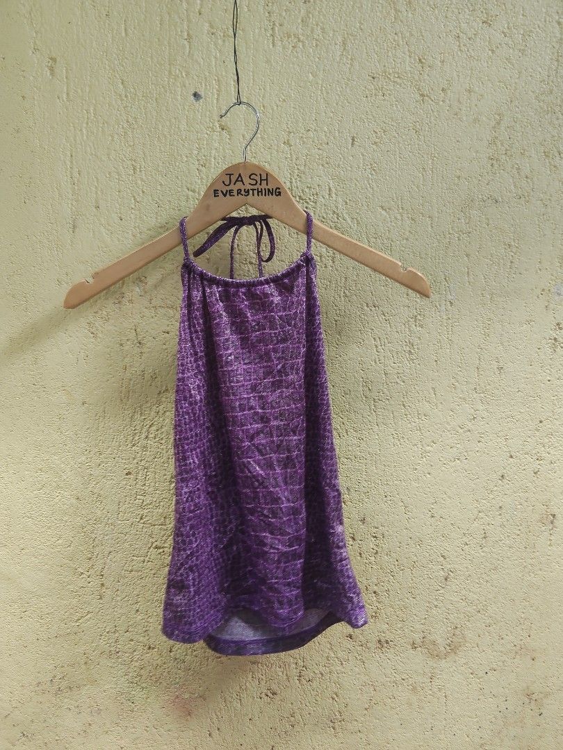 Purple Crocodile Print Halter Top (Category: Sleeveless) located in City of Isabela. Submitted by jasheverything (Listing ID 1464140190, Image 1). Description: - Adorable purple halter top - Unique crocodile print - Features a subtle shimmer in the fabric - Ties at the neck for an adjustable fit - Ideal for parties, festivals, or a fun night out - Flirty and eye-catching design Excellent Condition S to M 550+SF.