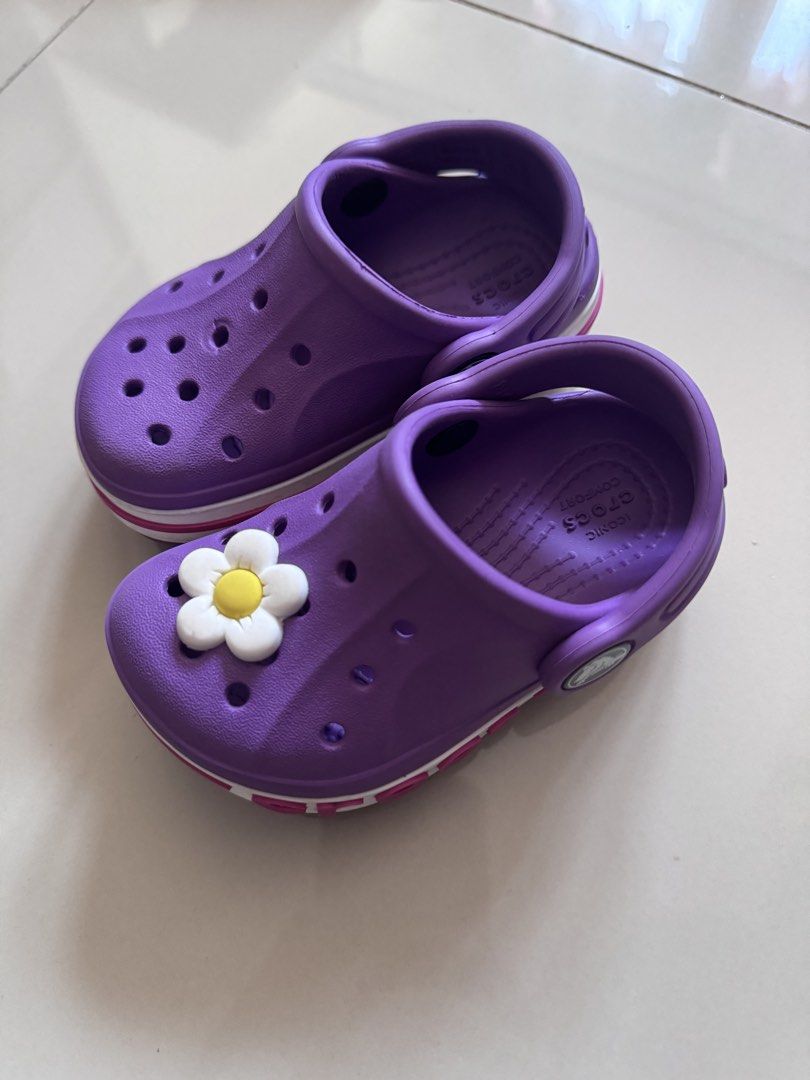 Purple Crocs with Flower Charm (Category: Babies & Kids Fashion) located in Quezon City. Submitted by jonahmprz (Listing ID 1464213066, Image 2). Description: -Original Crocs for baby -Size c5, bought in UK - Adorable purple Crocs for kids - Features a cute flower charm on the front - Easy slip-on design for quick wear - Durable and comfortable for playtime and casual outings - Iconic Crocs logo detail on side and sole.