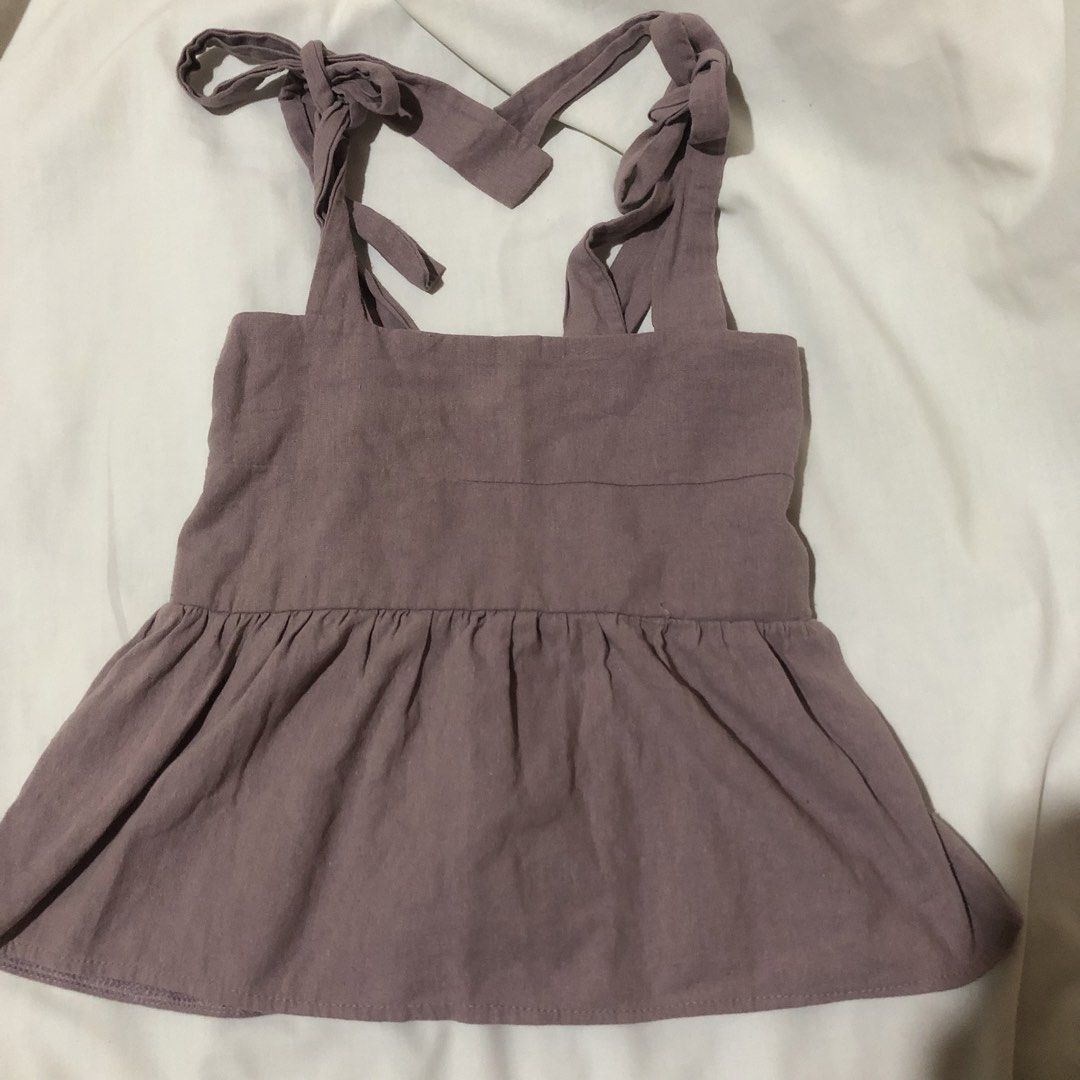 Purple Tie-Strap Peplum Top (Category: Sleeveless) located in Iloilo. Submitted by 080789 (Listing ID 1464249850, Image 1). Description: - Adorable purple top with adjustable tie straps. - Features a flattering square neckline. - Stylish peplum hem for a feminine silhouette. - Slightly textured fabric adds a unique touch. - Versatile for both casual outings and dressing up. - Easy to customize the fit with the tie straps..