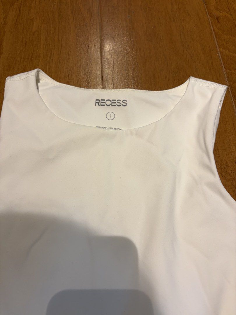 Recess The 90s Called Bodysuit white xs (Category: Blouses) located in Muntinlupa City. Submitted by secondhandlove12345 (Listing ID 1464276239, Image 2). Description: - Recess The 90s Called Bodysuit - Color: Panna Cotta - Size: 1 - Material: 75% Nylon, 25% Spandex - Features: Comfortable and stretchy fabric, snap closure at the bottom - Versatile: Great for layering or wearing on its own.