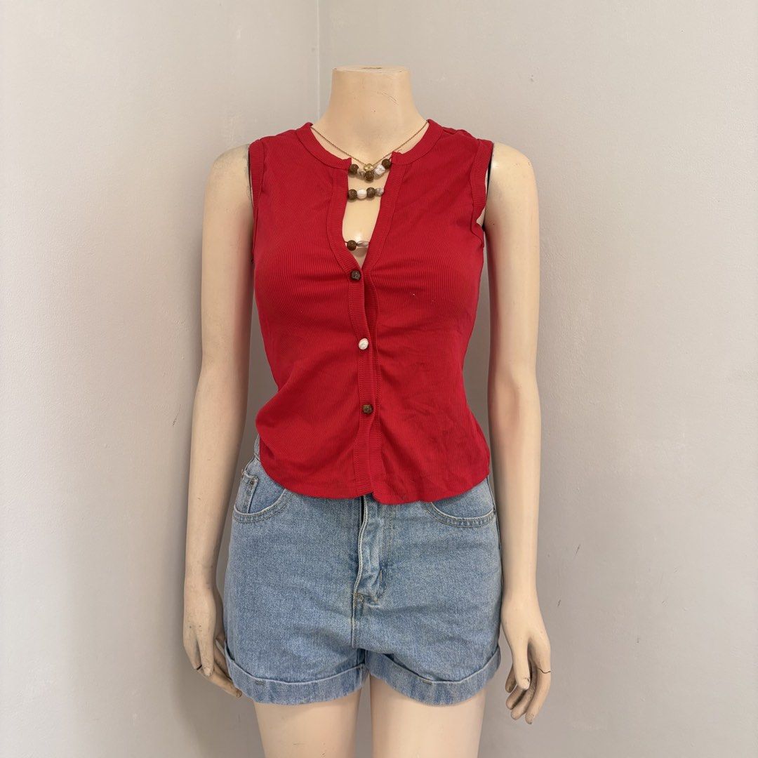 Red Ribbed Button-Up Sleeveless Tropical Top (Category: Sleeveless) located in Imus. Submitted by reloved.nd (Listing ID 1464256829, Image 1). Description: - Cute red ribbed sleeveless top - Features a button-up front with wooden buttons - Versatile for casual outings or nights with friends - Easy to style and comfortable to wear.