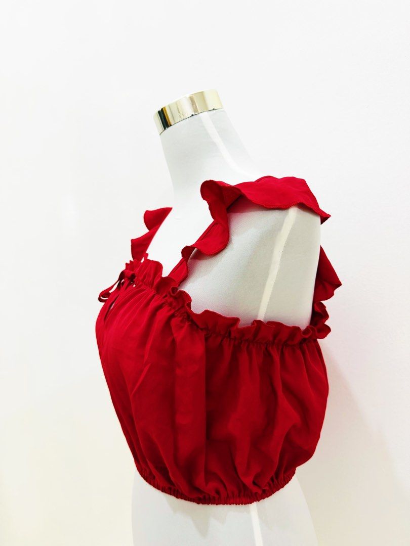 Red Ruffle Strap Crop Top with Tie Detail (Category: Sleeveless) located in Manila. Submitted by e.louise (Listing ID 1464332890, Image 2). Description: - Adorable red crop top - Features stylish ruffle straps - Cute tie detail at the front - Comfortable elasticated hem - Ideal for summer outfits - Versatile: pairs well with shorts or skirts - Can be worn alone or layered.