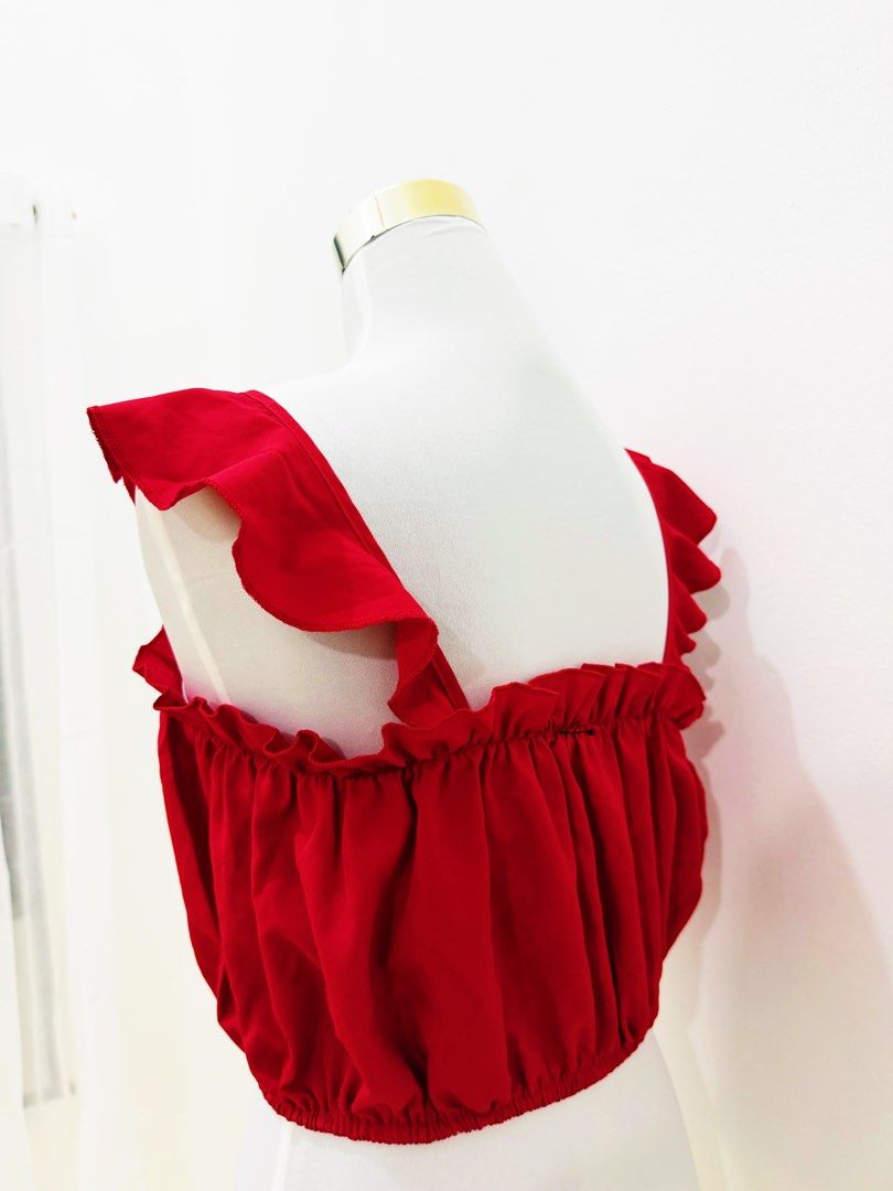 Red Ruffle Strap Crop Top with Tie Detail (Category: Sleeveless) located in Manila. Submitted by e.louise (Listing ID 1464332890, Image 3). Description: - Adorable red crop top - Features stylish ruffle straps - Cute tie detail at the front - Comfortable elasticated hem - Ideal for summer outfits - Versatile: pairs well with shorts or skirts - Can be worn alone or layered.