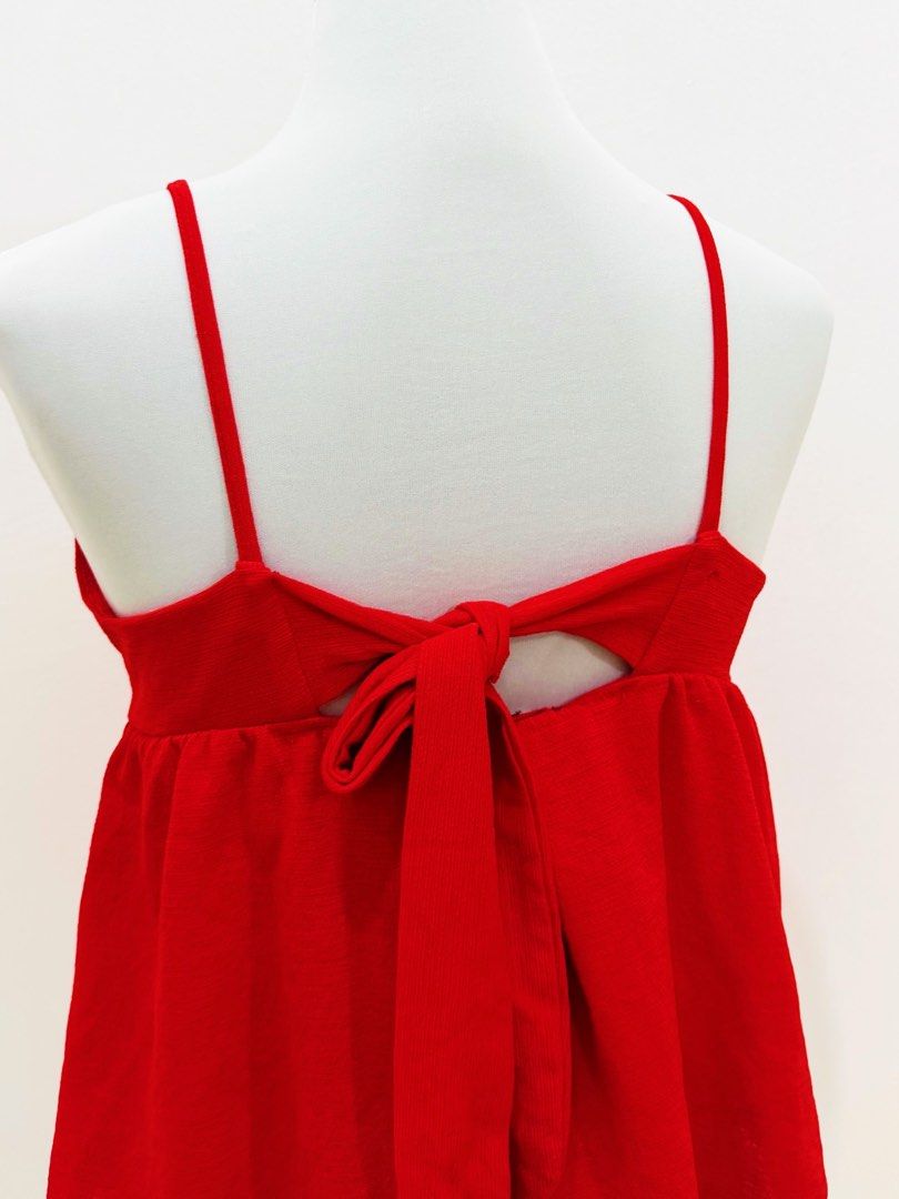 Red Spaghetti Strap V-Neck Top with Back Tie (Category: Sleeveless) located in Manila. Submitted by e.louise (Listing ID 1464334172, Image 2). Description: - Cute red top - Spaghetti straps - V-neck front - Back cutout with tie closure - Subtle textured fabric pattern - Versatile for casual or dressed-up looks.