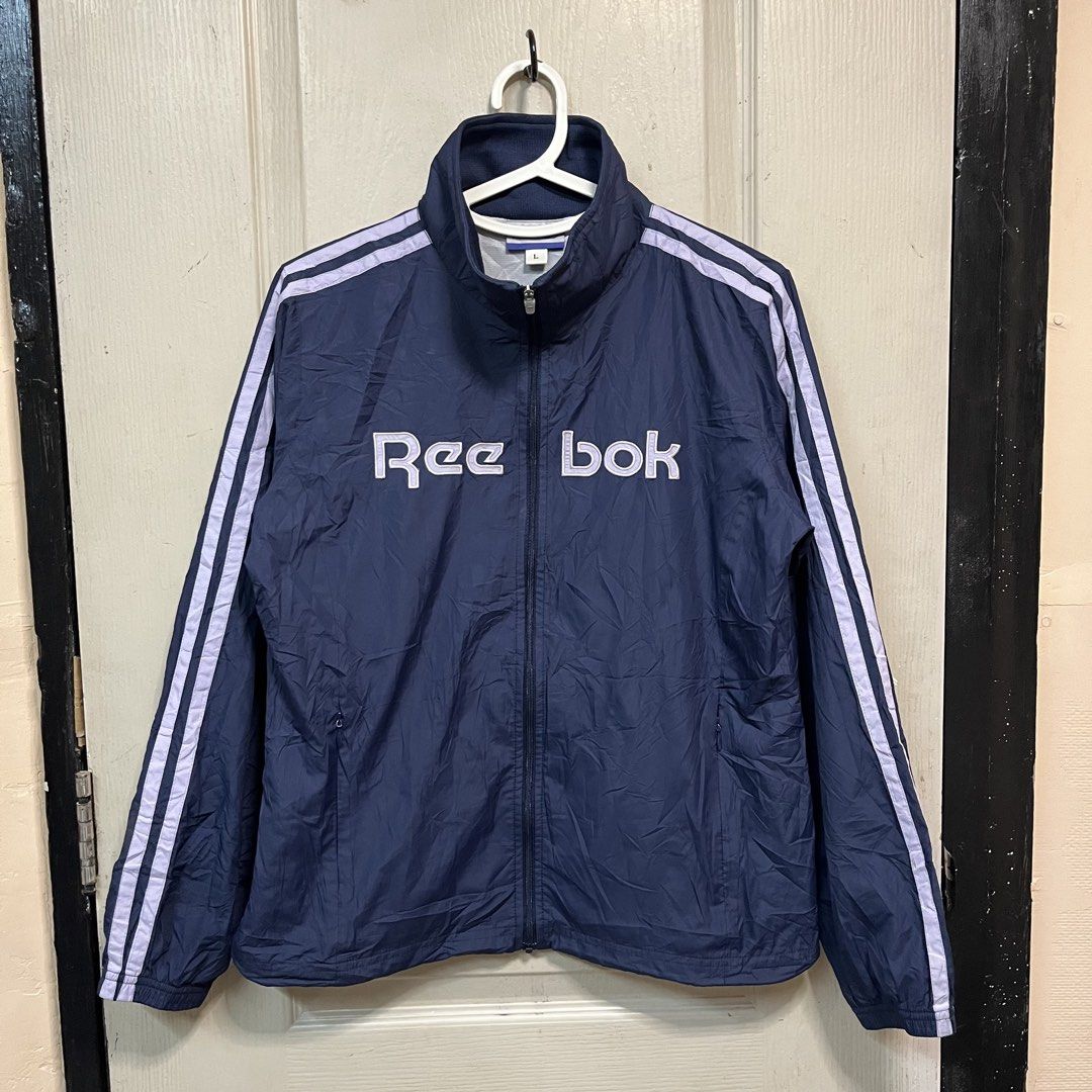 Reebok | Windbreaker for women (Category: Coats, Jackets and Outerwear) located in Quezon City. Submitted by giometryyy (Listing ID 1464293194, Image 1). Description: 23 x 19 small excellent condition embroidered spell out stripes on sleeves 📍East Fairview, QC 🛵Lalam0ve / JnT 💰Payment first .