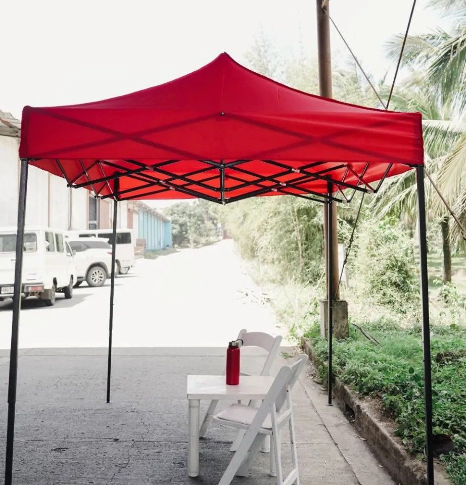 Retractable Tent (Category: Outdoor Furniture) located in Manila. Submitted by jaemalda (Listing ID 1464173956, Image 2). Description: - Easy to set up and take down - Sturdy frame for stability - Provides excellent shade - Folds compactly for easy storage and transport - Ideal for markets, parties, and outdoor events - Comes in a vibrant red color.