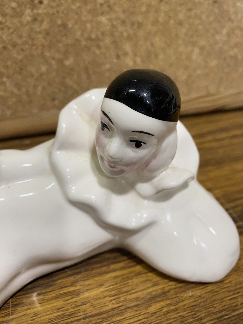 Retro 1980s White Ceramic Pierrot Figurine (Category: Figurines & Statues) located in Calamba. Submitted by chebvintagedepot (Listing ID 1464245246, Image 2). Description: [B19-02] This white glossy ceramic Pierrot figurine is posed lying on its side with one knee raised. It wears a classic black cap and a ruffled frilly collar, giving it a distinctive theatrical look. The design has a retro 1980s interior décor feel with Art Deco-inspired stylin