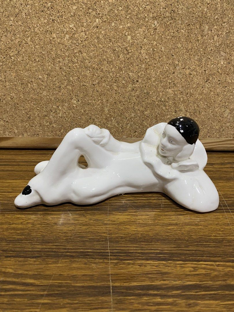 Retro 1980s White Ceramic Pierrot Figurine (Category: Figurines & Statues) located in Calamba. Submitted by chebvintagedepot (Listing ID 1464245247, Image 1). Description: [B19-01] This white glossy ceramic Pierrot figurine is posed lying on its side with one knee raised. It wears a classic black cap and a ruffled frilly collar, giving it a distinctive theatrical look. The design has a retro 1980s interior décor feel with Art Deco-inspired stylin