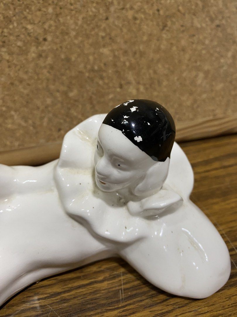Retro 1980s White Ceramic Pierrot Figurine (Category: Figurines & Statues) located in Calamba. Submitted by chebvintagedepot (Listing ID 1464245247, Image 2). Description: [B19-01] This white glossy ceramic Pierrot figurine is posed lying on its side with one knee raised. It wears a classic black cap and a ruffled frilly collar, giving it a distinctive theatrical look. The design has a retro 1980s interior décor feel with Art Deco-inspired stylin