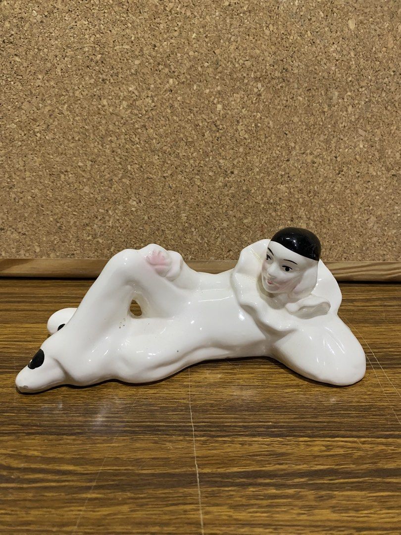 Retro 1980s White Ceramic Pierrot Figurine (Category: Figurines & Statues) located in Calamba. Submitted by chebvintagedepot (Listing ID 1464245246, Image 1). Description: [B19-02] This white glossy ceramic Pierrot figurine is posed lying on its side with one knee raised. It wears a classic black cap and a ruffled frilly collar, giving it a distinctive theatrical look. The design has a retro 1980s interior décor feel with Art Deco-inspired stylin