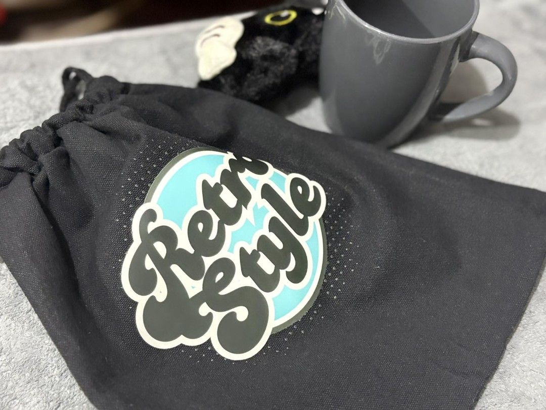 Retro Style Drawstring Bag (Category: Shoulder Bags) located in Pasig City. Submitted by rnr2026 (Listing ID 1464247892, Image 2). Description: - Stylish black drawstring bag - Features a cool 'Retro Style' graphic with a turquoise circle - Ideal for carrying small essentials or as a gift bag - Secure drawstring closure - Made from durable fabric.