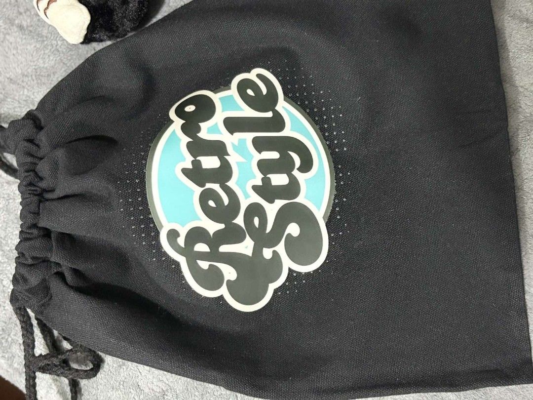 Retro Style Drawstring Bag (Category: Shoulder Bags) located in Pasig City. Submitted by rnr2026 (Listing ID 1464247892, Image 1). Description: - Stylish black drawstring bag - Features a cool 'Retro Style' graphic with a turquoise circle - Ideal for carrying small essentials or as a gift bag - Secure drawstring closure - Made from durable fabric.