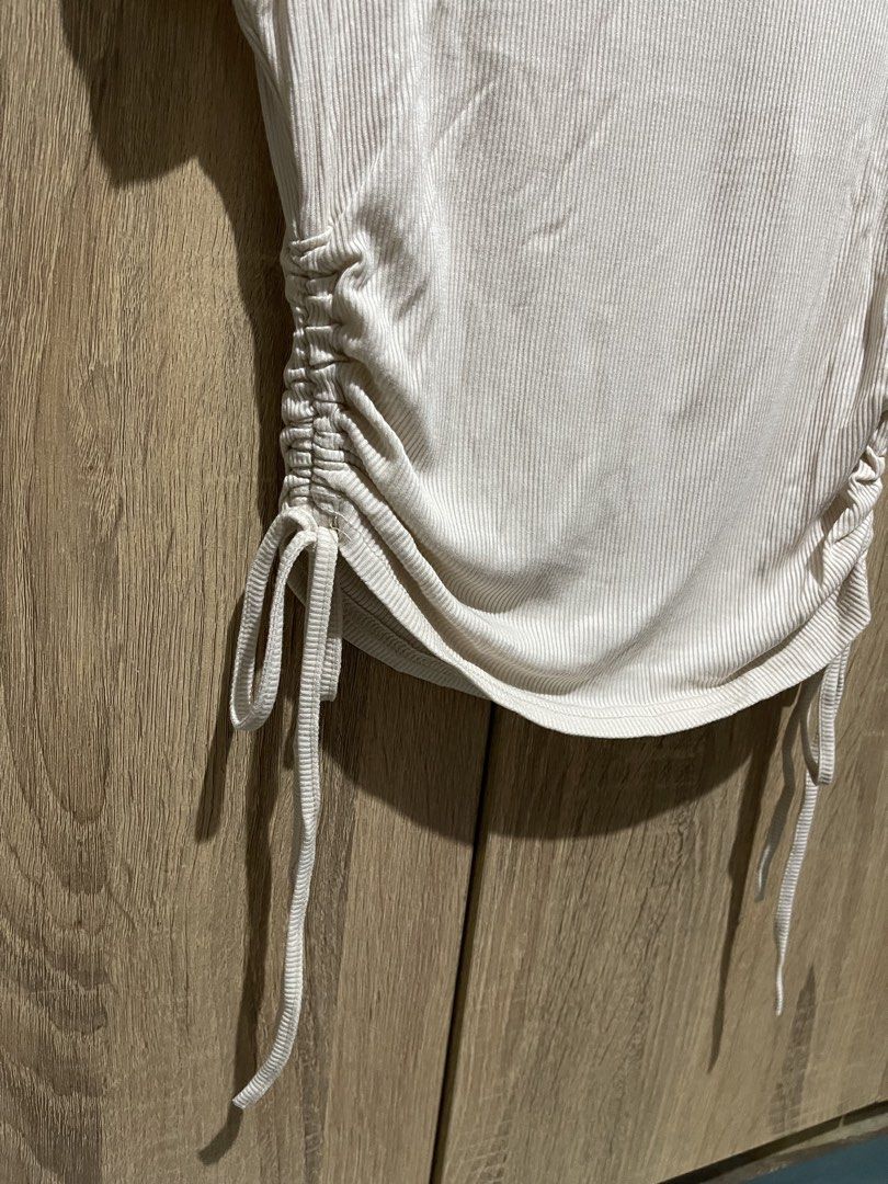 Ribbed Ruched Side T-shirt (Category: Shirts) located in Manila. Submitted by preloveditems_jem (Listing ID 1464303123, Image 2). Description: White ribbed t-shirt with ruched sides. Adjustable drawstring ties on both sides. Short sleeves and a crew neck. Stretchy material for a comfortable fit. Looks good with jeans or skirts. Nude colored..