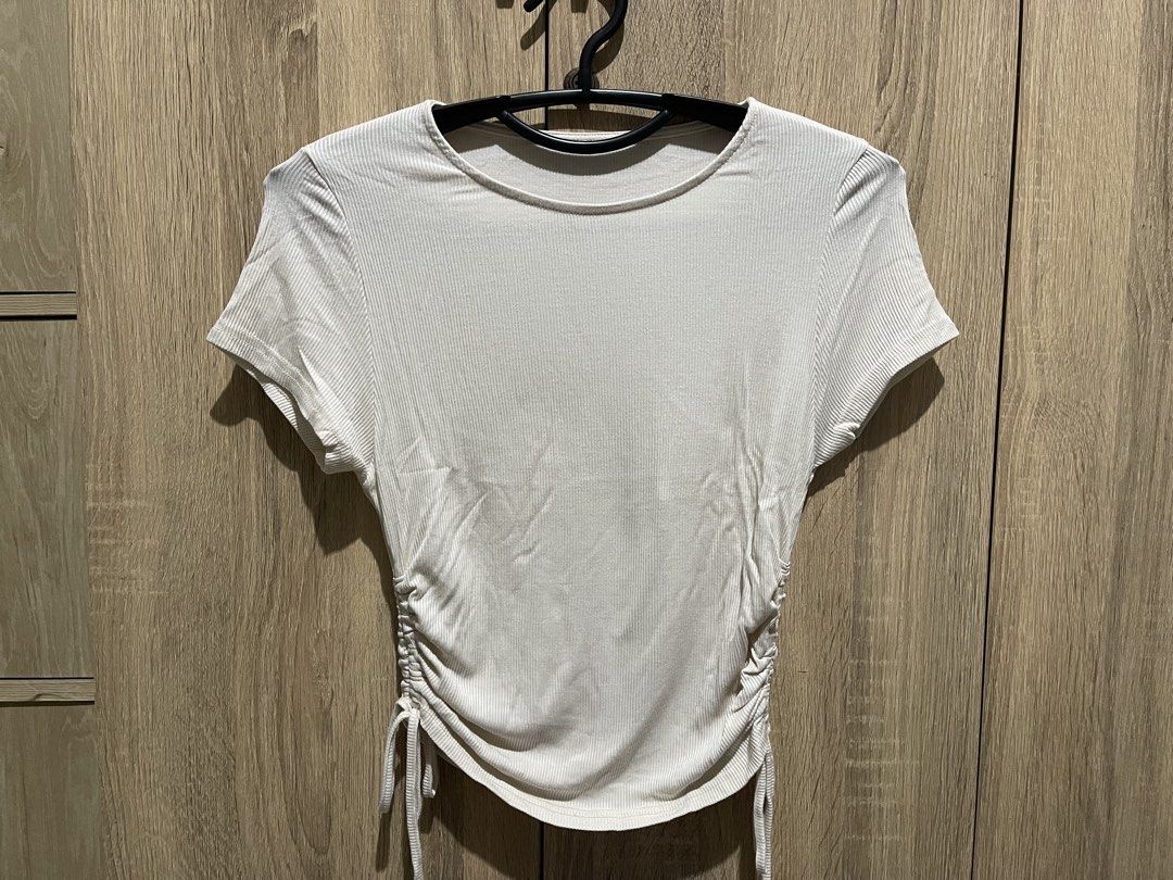 Ribbed Ruched Side T-shirt (Category: Shirts) located in Manila. Submitted by preloveditems_jem (Listing ID 1464303123, Image 3). Description: White ribbed t-shirt with ruched sides. Adjustable drawstring ties on both sides. Short sleeves and a crew neck. Stretchy material for a comfortable fit. Looks good with jeans or skirts. Nude colored..