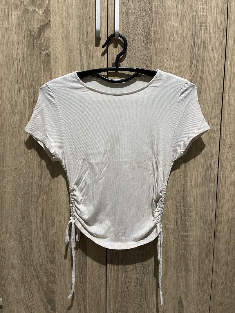 Ribbed Ruched Side T-shirt (Category: Shirts) located in Manila. Submitted by preloveditems_jem (Listing ID 1464303123, Image 1). Description: White ribbed t-shirt with ruched sides. Adjustable drawstring ties on both sides. Short sleeves and a crew neck. Stretchy material for a comfortable fit. Looks good with jeans or skirts. Nude colored..