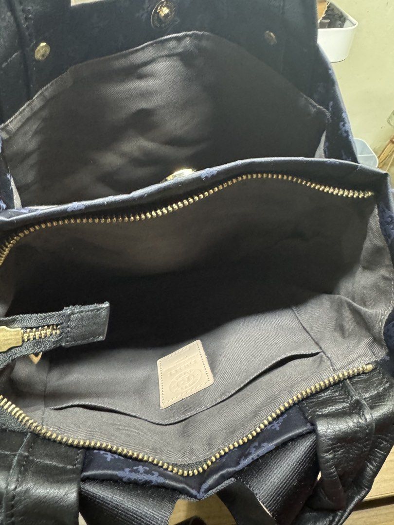 Russet Tokyo Navy Monogram Backpack Tote Bag (Category: Luxury Bags & Wallets) located in Manila. Submitted by xenasales (Listing ID 1464212667, Image 3). Description: - Navy blue Russet Tokyo bag - All-over signature monogram pattern - Versatile: can be used as a tote or backpack - Adjustable straps - Genuine leather handles and trim - Secure zipper closure - Interior features: 1 zippered pocket, 1 slip pocket - Ideal for everyday use.