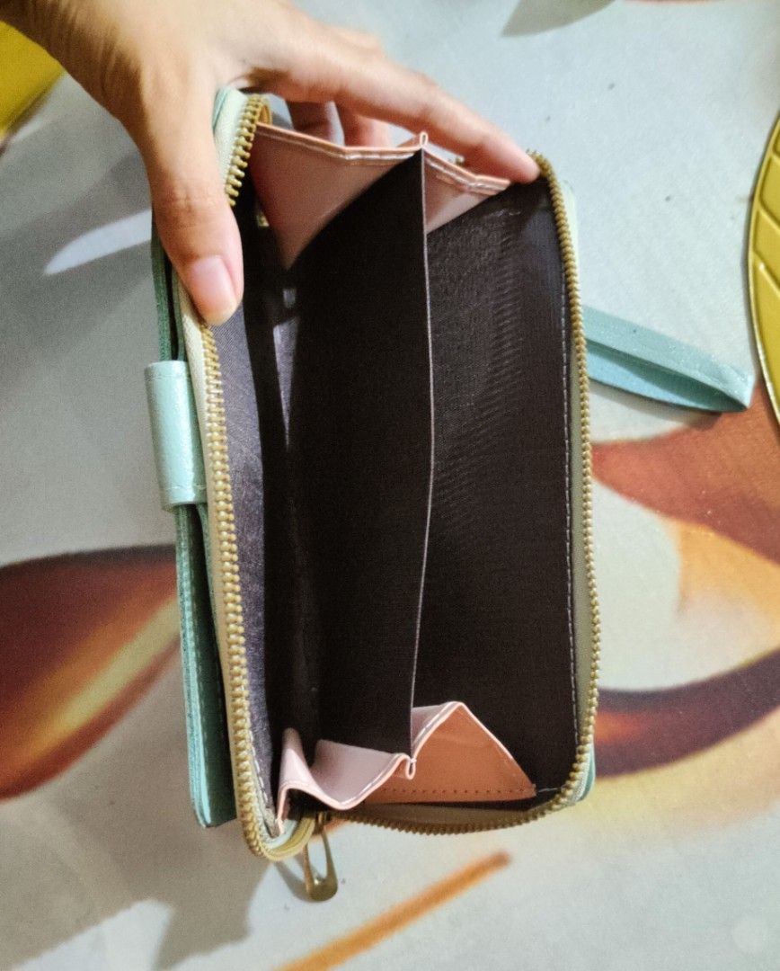 Sage Green Long Wallet/Purse (Category: Wallets & Card holders) located in Lapu Lapu. Submitted by nikkomango (Listing ID 1464308813, Image 3). Description: RUSH ‼️Sage Green Long Wallet/Purse LP: ₱60 MOP: GoTyme, GCash, Maribank Delivery: maxim 📍: Brgy. Looc, Lapu-Lapu NOTES‼️ - never used, very small pen markings at the back part but barely noticeable, no damages - strictly no refunds - Final selling price means no negotiation - I cannot shoul