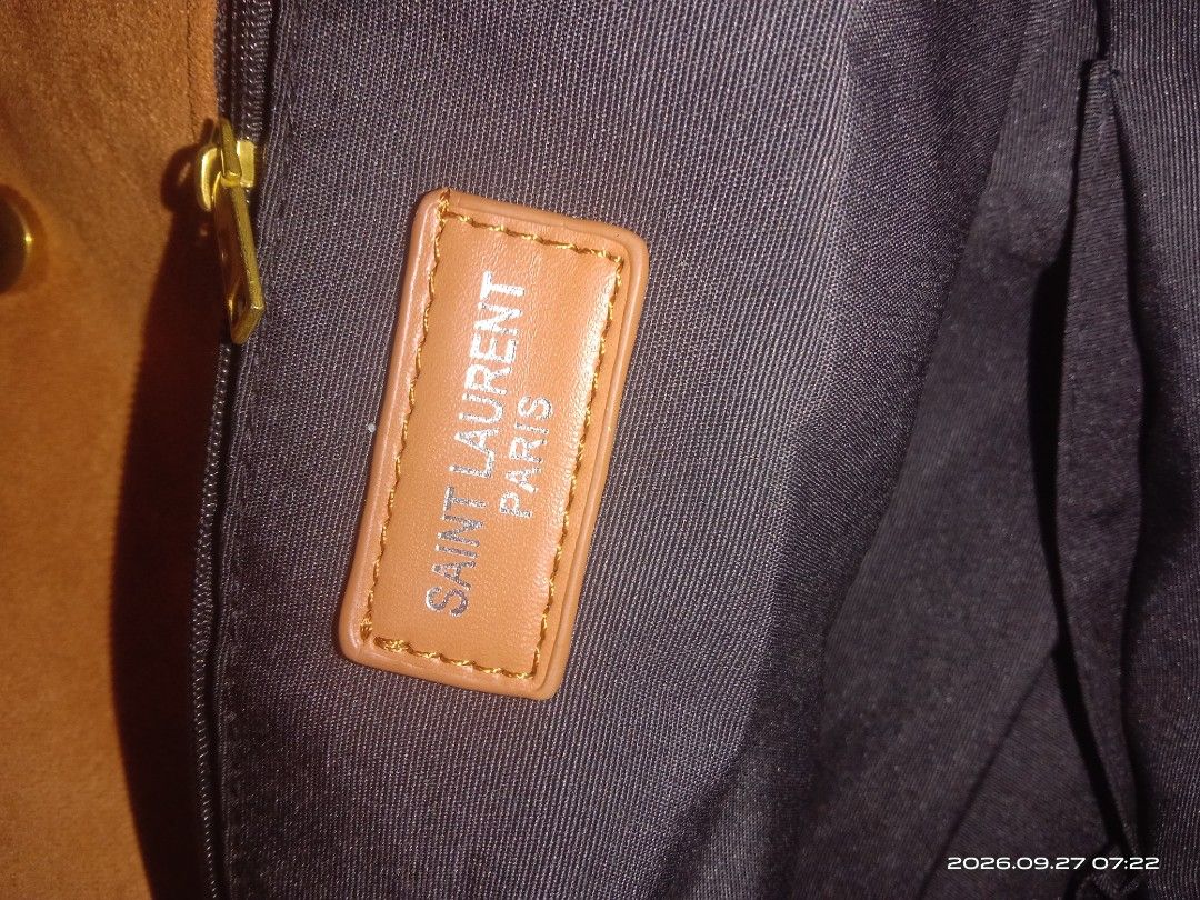 Saint Laurent Paris Suede Shoulder Bag (Category: Shoulder Bags) located in Las Pinas. Submitted by raymond088 (Listing ID 1464354596, Image 2). Description: - Brand: Saint Laurent Paris - Material: Brown Suede - Hardware: Gold YSL logo on front - Interior: Zippered pocket with Saint Laurent Paris label - Strap: Chain strap detail - Condition: Great for everyday use.