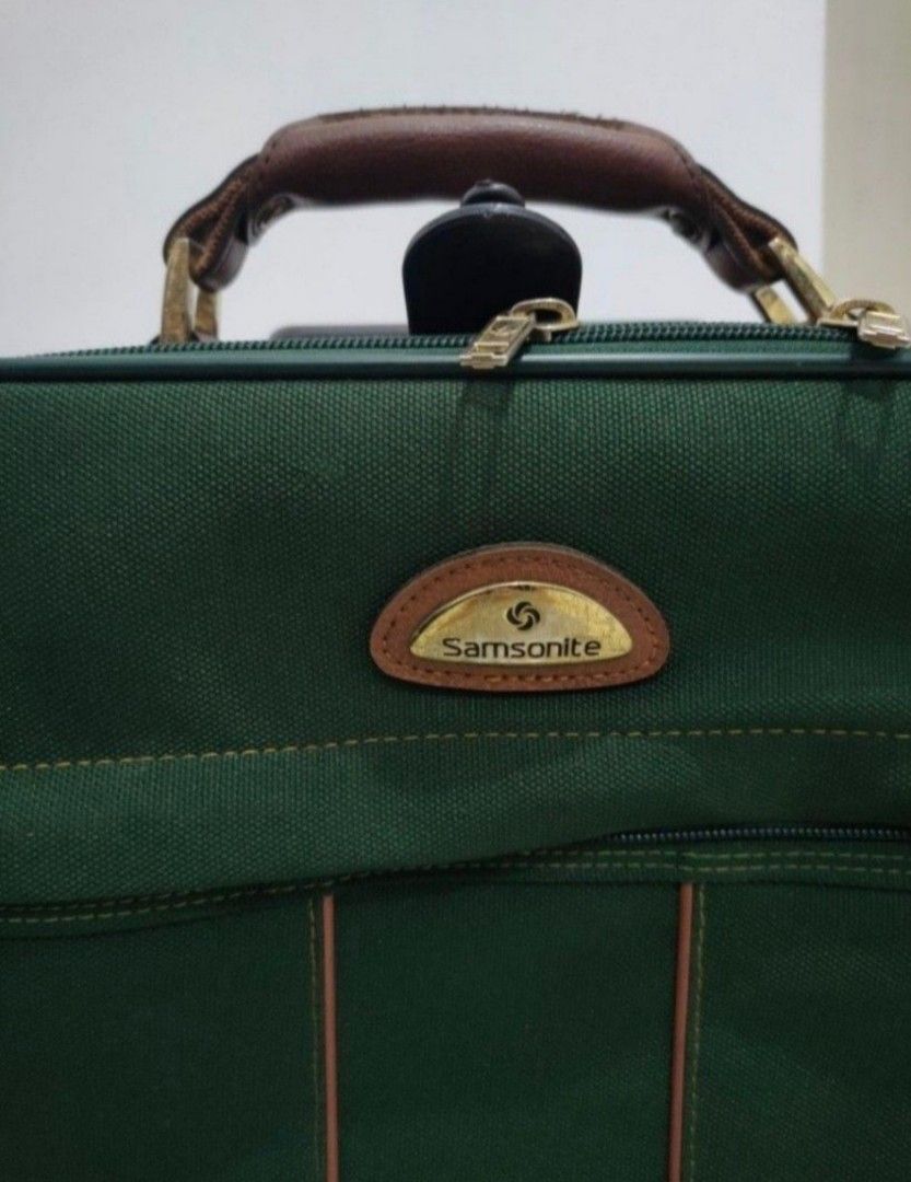 Samsonite Green Rolling Suitcase with Brown Leather Accents (Category: Luggage) located in Quezon City. Submitted by maxsab (Listing ID 1464235825, Image 3). Description: - Stylish green rolling suitcase with elegant brown leather trim and handle. - Effortless travel with a retractable pull handle and smooth-rolling wheels. - Convenient storage: features a front zippered pocket and a spacious main compartment. - Ideal size for getaways: approxima