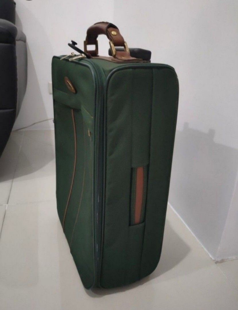 Samsonite Green Rolling Suitcase with Brown Leather Accents (Category: Luggage) located in Quezon City. Submitted by maxsab (Listing ID 1464235825, Image 1). Description: - Stylish green rolling suitcase with elegant brown leather trim and handle. - Effortless travel with a retractable pull handle and smooth-rolling wheels. - Convenient storage: features a front zippered pocket and a spacious main compartment. - Ideal size for getaways: approxima