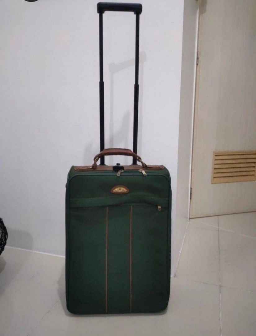 Samsonite Green Rolling Suitcase with Brown Leather Accents (Category: Luggage) located in Quezon City. Submitted by maxsab (Listing ID 1464235825, Image 2). Description: - Stylish green rolling suitcase with elegant brown leather trim and handle. - Effortless travel with a retractable pull handle and smooth-rolling wheels. - Convenient storage: features a front zippered pocket and a spacious main compartment. - Ideal size for getaways: approxima