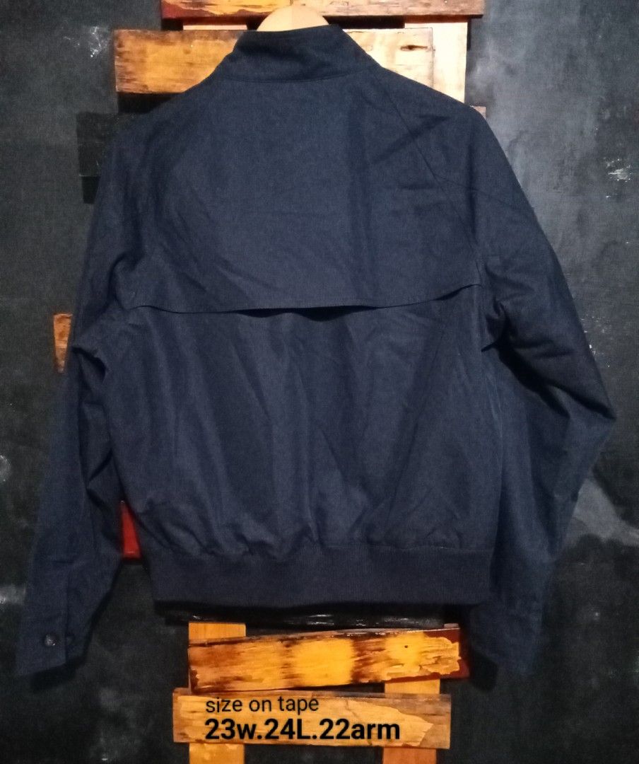 SATUR Navy Bomber Jacket with Embroidered Logo (Category: Coats, Jackets and Outerwear) located in Caloocan City. Submitted by calmcat_6fd4f7 (Listing ID 1464142170, Image 3). Description: - Navy blue SATUR bomber jacket - Size: M - Zip-up front closure - Buttoned pockets - Small embroidered logo on chest - Ribbed cuffs and hem - Made in China.