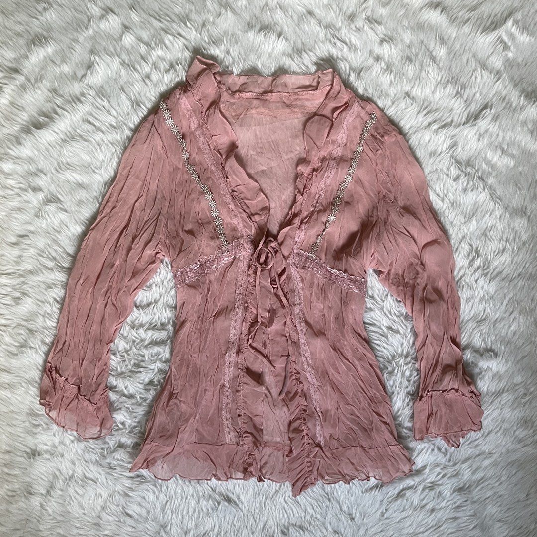 Sheer Pink Blouse with Lace and Tie Front (Category: Blouses) located in Maasin. Submitted by taraa18 (Listing ID 1464297122, Image 1). Description: - Sheer pink long-sleeved blouse - Delicate lace trim along neckline - Floral bead details on neckline - Tie front closure - Crinkled fabric texture - Made in Hong Kong - Ideal for layering or a vintage aesthetic.