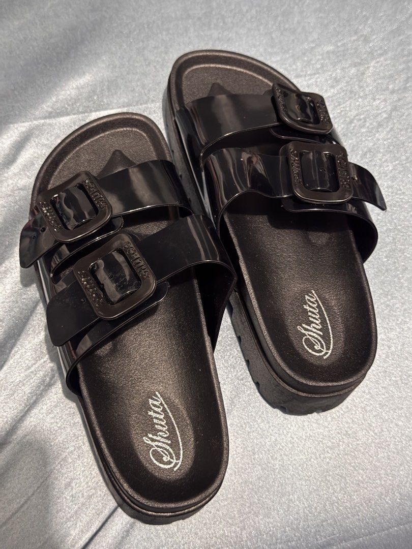 Shuta Black Double Buckle Platform Slides Sandals (Category: Flats & Sandals) located in Manila. Submitted by _dyclutter (Listing ID 1464225819, Image 1). Description: • Black Shuta slides •bnew, never been used • Double buckle design • Platform sole for added height • Rugged tread pattern on sole • Size: 40-41 but fit to Size 37-38 .