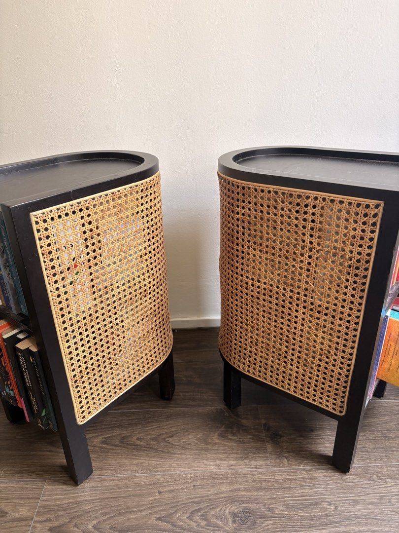 Side table (Category: Shelves, Cabinets & Racks) located in Singapore. Submitted by shaffan (Listing ID 1464273695, Image 2). Description: - Set of 2 black accent bookcases - Features curved cane front panels - Stands on four legs - Ideal for displaying books and decor - Adds a stylish touch to any room Selling as a set of 2 for $200.