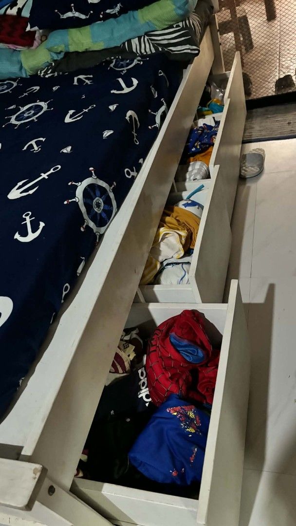 Single Bed Frame with Headboard and Storage Drawers (Category: Bed Frames & Mattresses) located in Makati City. Submitted by ag1994 (Listing ID 1464301053, Image 3). Description: - White single bed frame (with slightly paint chips) - Tufted headboard (detachable) - Built-in drawers for storage (4) - Includes uratex single bed foam - Ideal for space-saving.