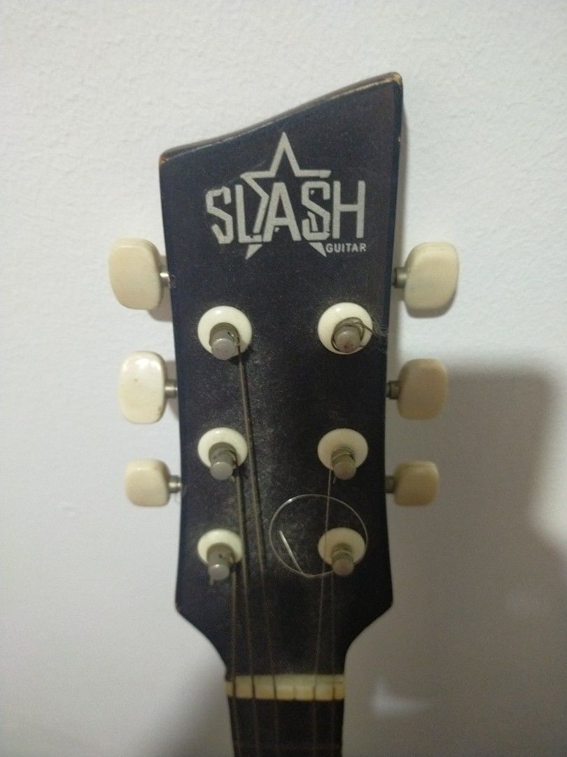 Slash Acoustic Guitar - Sunburst Finish (Category: Musical Instruments) located in Paranaque City. Submitted by gentle.declutter (Listing ID 1463394451, Image 2). Description: Great starter guitar — solid & ready to play ✅ Brand: SLASH Guitar — entry-level full-size acoustic ✅ Finish: Rich dark red sunburst — classic look ✅ Body: Dreadnought style — loud, balanced tone ✅ Condition: • ⚠️ One string missing — easy & cheap to replace • ✅ No other da