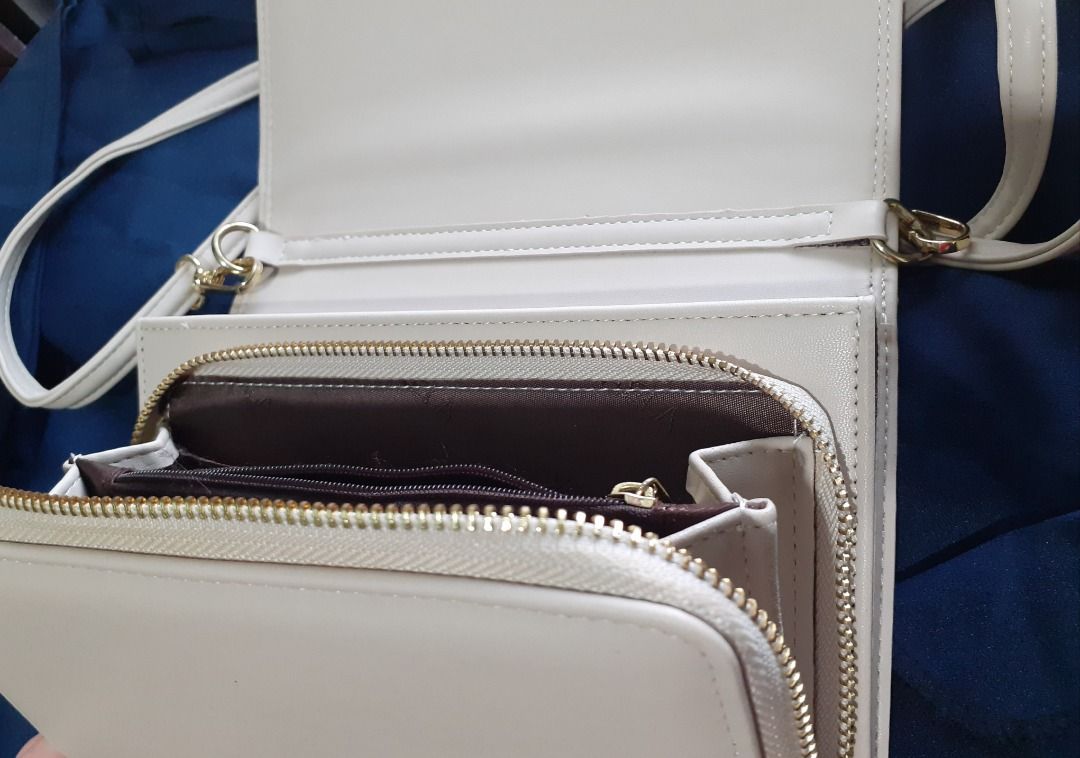 Sling Bag - Michaela (Category: Cross-body Bags) located in Caloocan City. Submitted by noblecat_5a849d (Listing ID 1464230544, Image 3). Description: - Cream colored crossbody bag - Quilted chevron pattern on front flap - Gold-tone metal 'M' logo - Zip closure with a separate compartment - Ideal for everyday wear.