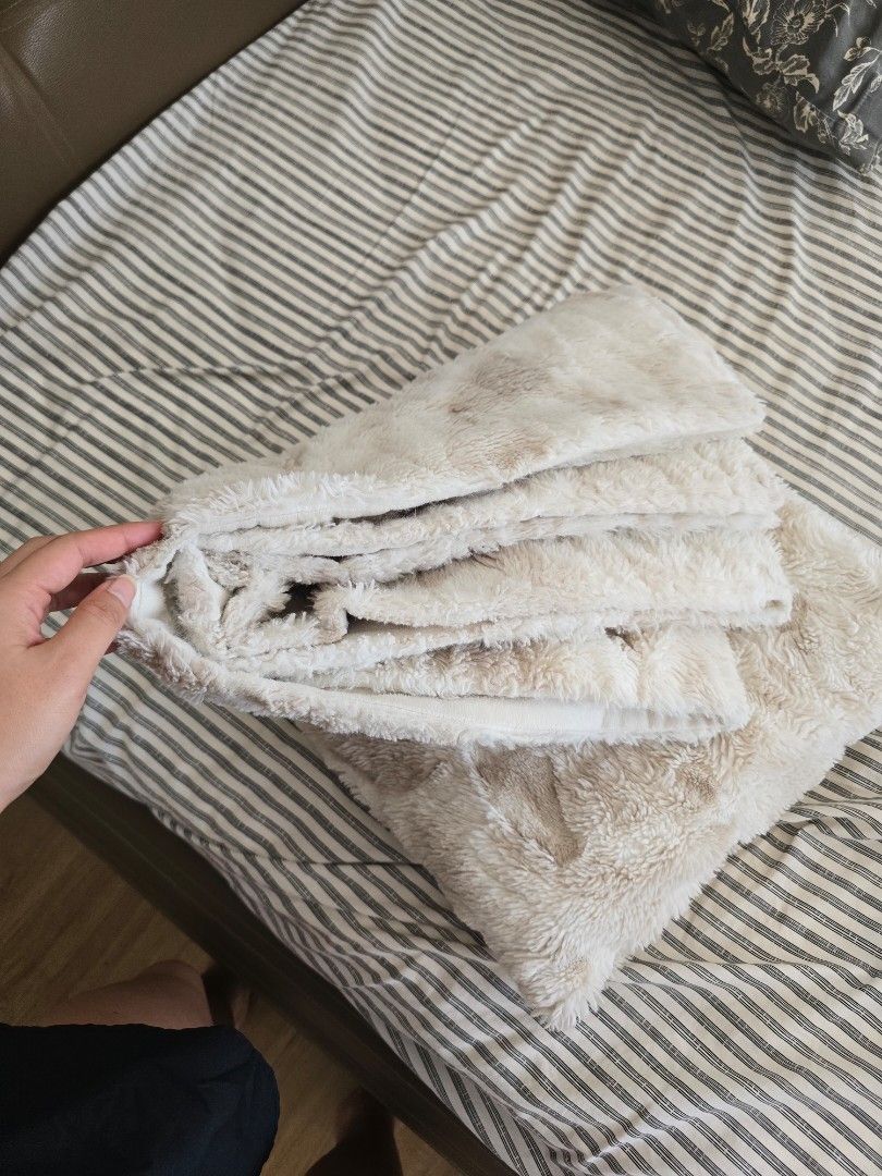 Soft Cream Faux Fur Throw Blanket (Category: Bedding & Towels) located in Paranaque City. Submitted by incognitopawikan (Listing ID 1464155399, Image 2). Description: - Super soft and cozy faux fur throw blanket - Creamy beige color with subtle darker markings - Ideal for snuggling on the couch - Adds a warm layer to your bed - Easy to care for - Perfect for chilly evenings.